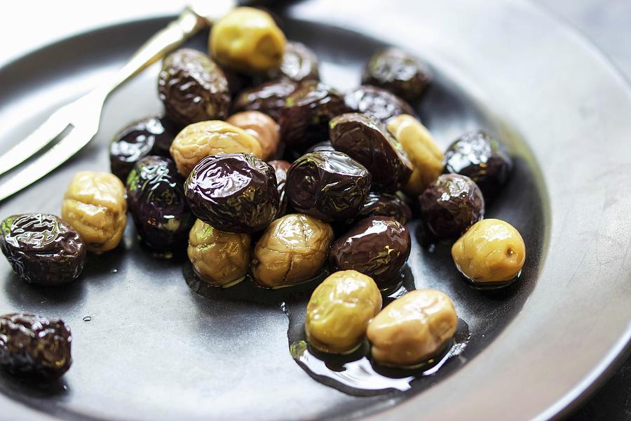 Black And Green Olives In Olive Oil Photograph by Charlotte Von Elm