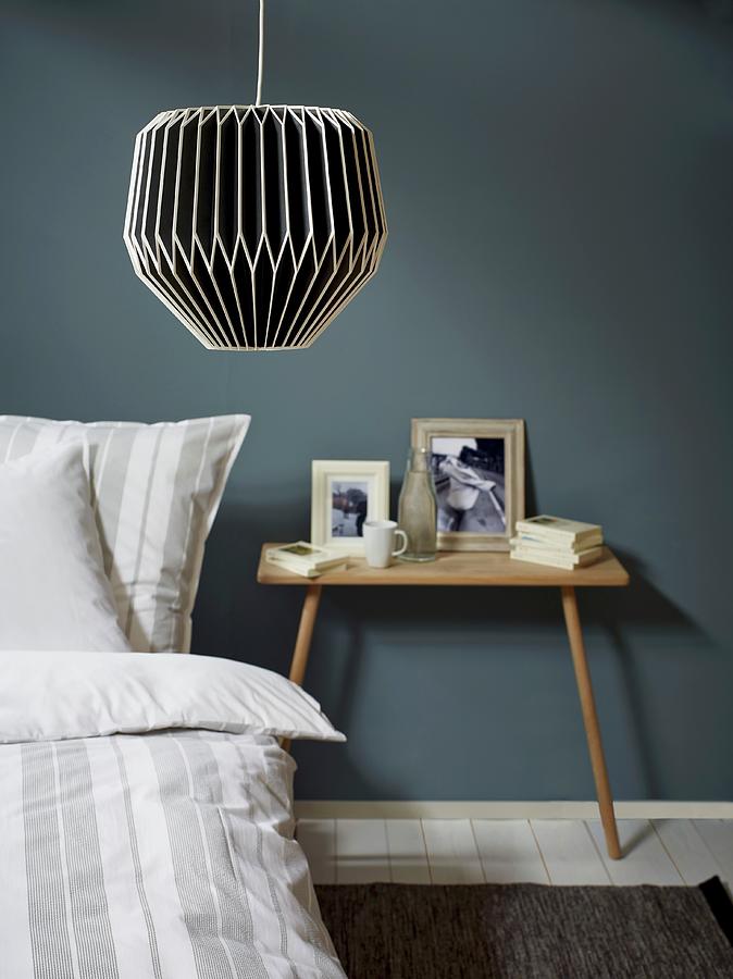 Black And White Lantern-style Lamp Above Bed With Striped Bed Linen And Bedside Table Photograph by Michael Lffler