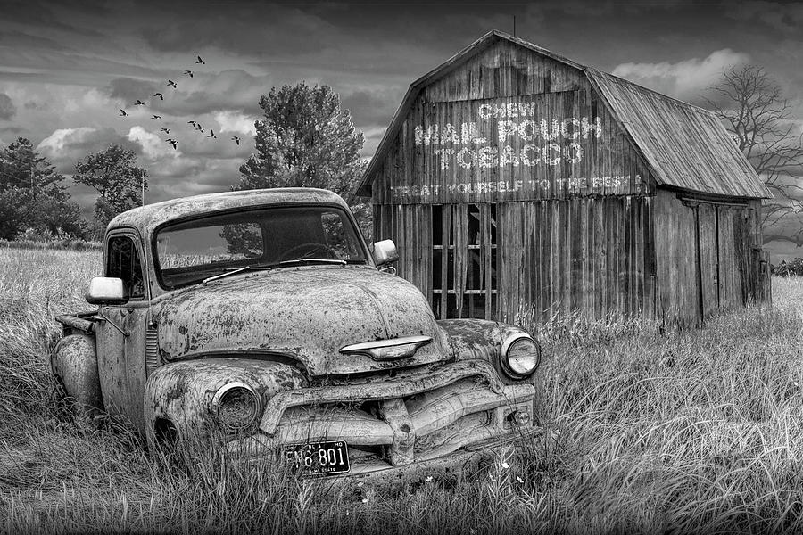 Black and White of Rusted Chevy Pickup Truck in a Rural Landscape by a Mail Pouch Tobacco Barn Photograph by Randall Nyhof