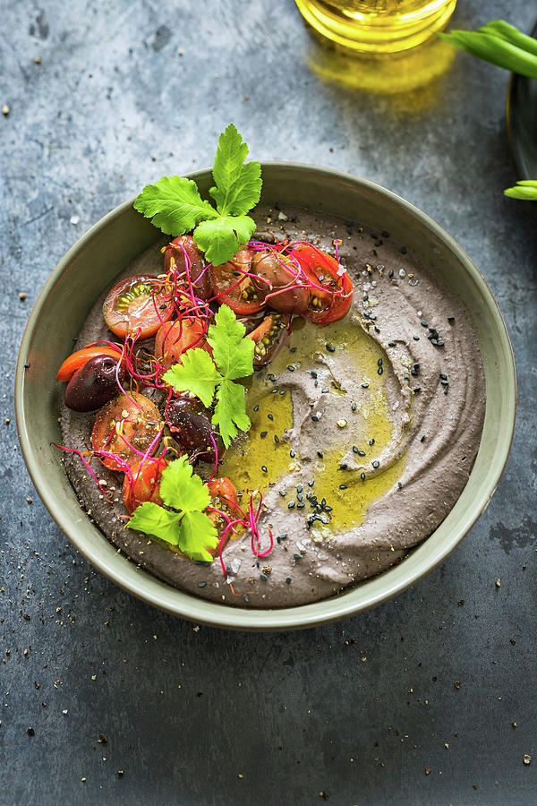 Black Bean Hummus With Tomatoes, Olives And Fresh Mitsuba Herb Photograph by Osmykolorteczy