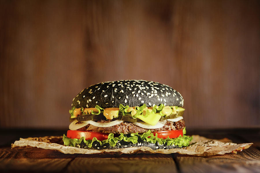 Black Burger On Paper On A Dark Background Photograph by Reiand