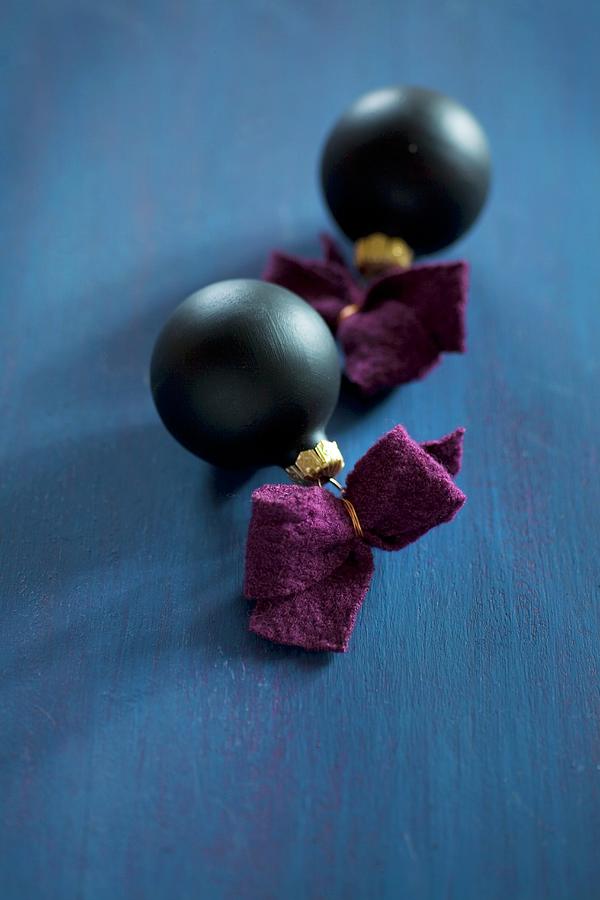 Black Christmas-tree Baubles With Felt Ribbons Photograph by Alicja Koll
