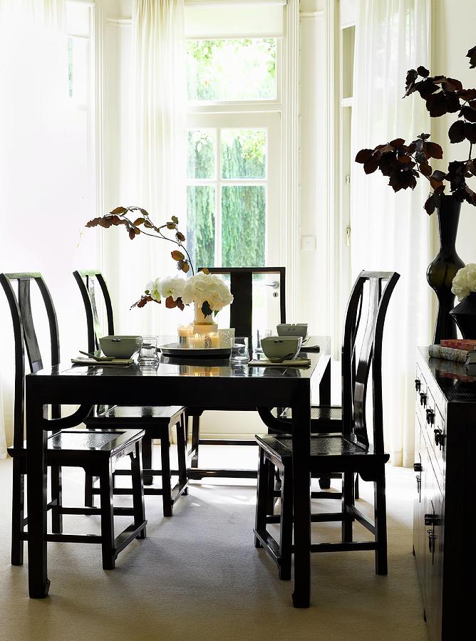 Black Dining Table, Chairs And Cabinet Photograph by Dan Duchars