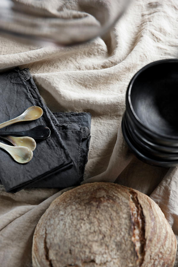Black Dishes, Black Napkins And Bread On A Beige Linen Tablecloth Photograph by Lykke Foged & Morten Holtum