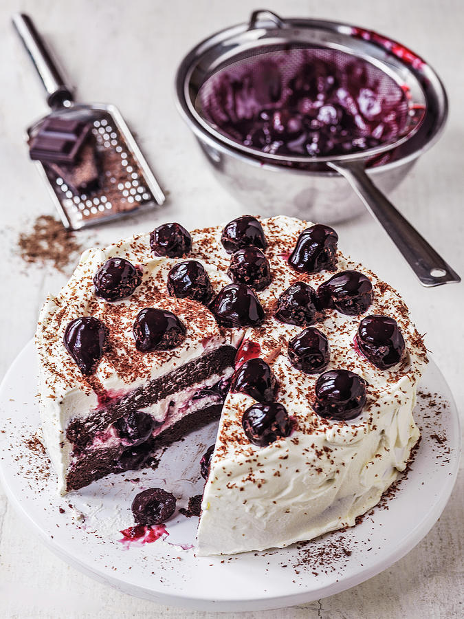 Black Forest Gateau With Glazed Cherries And A Slice Cut Out Along With Grated Chocolate Photograph by Michael Paul