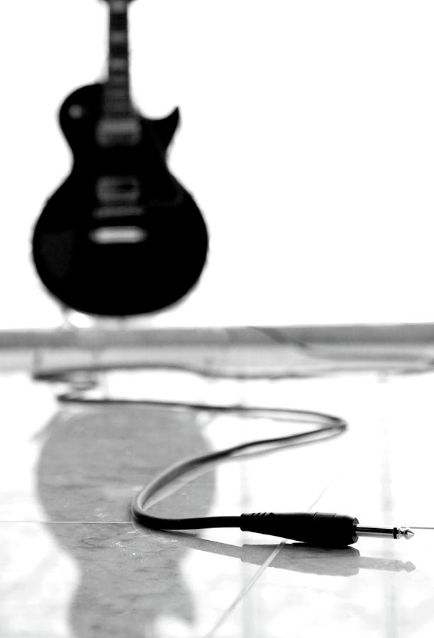Black Guitar And Cord With Copy Spapce Photograph by Clickhere