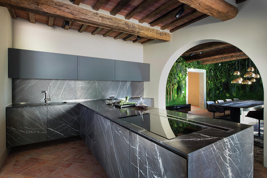 Black Marble Panels And Rustic Beams In Modern Kitchen Photograph by Francesca Pagliai