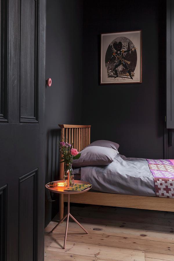 Black Painted Bedroom With Wooden Bed Wooden Floor And Lit Lamp And Posy Of Roses On Tray Table Simon Maxwell Photography 