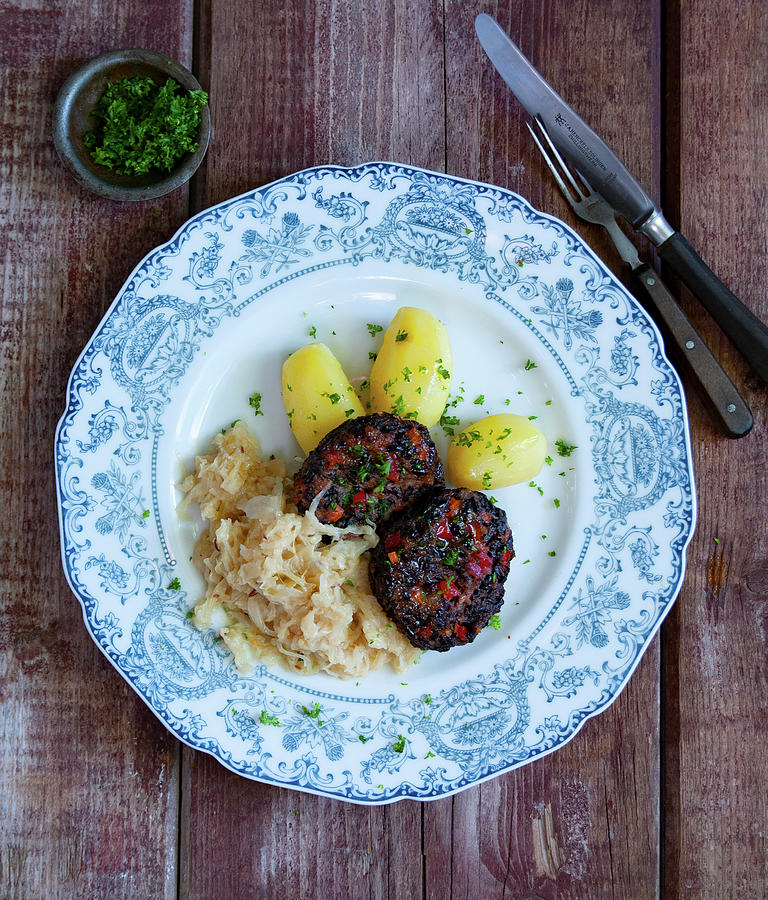 Black Pudding And Rice Meatballs With Sauerkraut And Parsley Potatoes Photograph by Udo Einenkel