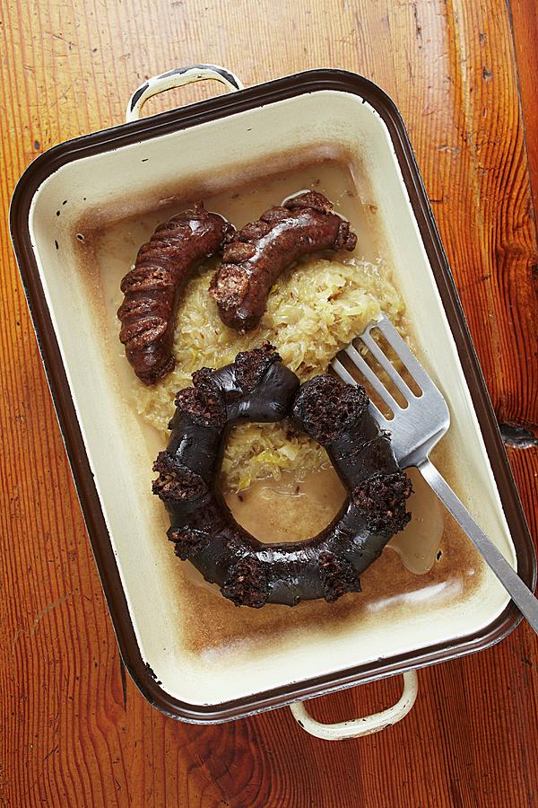 Black Pudding, Liver Sausages And Sauerkraut In A Baking Dish Photograph by Herbert Lehmann