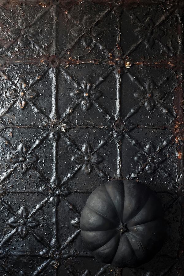 Black Pumpkin On Metal Surface Photograph by Great Stock!