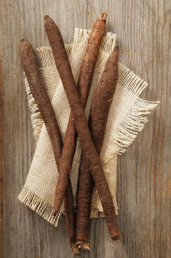 Black Salsify On A Beige Cloth Photograph by Jean-christophe Riou