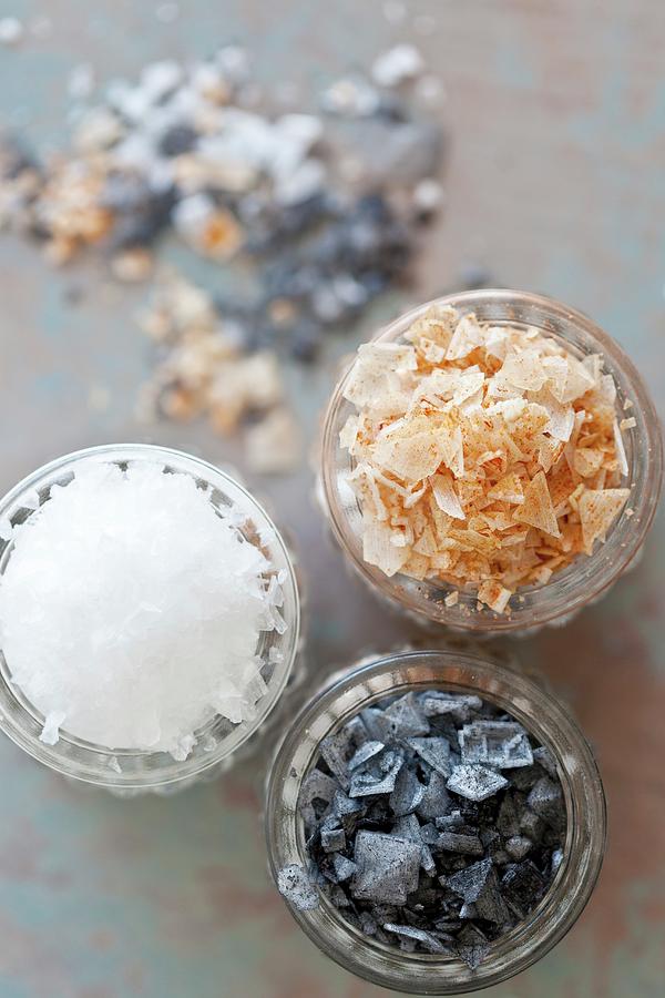 Black Salt, Paprika Salt And Sea Salt Flakes In Glasses Photograph by ...