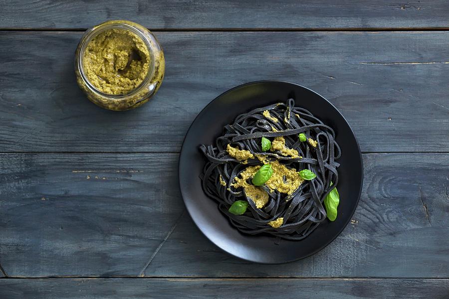 Black Squid Ink Pasta With Basil Pesto And Fresh Basil Leaves Photograph by Malgorzata Laniak