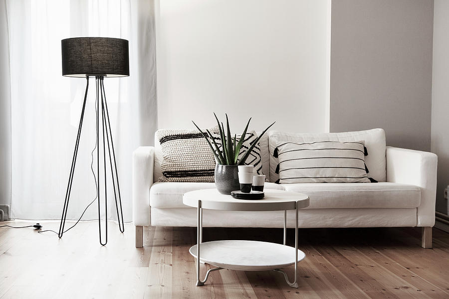 Black Standard Lamp Next To Pale Couch And Coffee Table Photograph by Hej.hem Interior