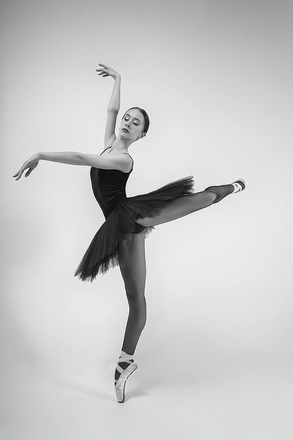 Black Swan. A Ballerina In A Black Tutu Shows Elements Of Ballet Photograph by Alexandr