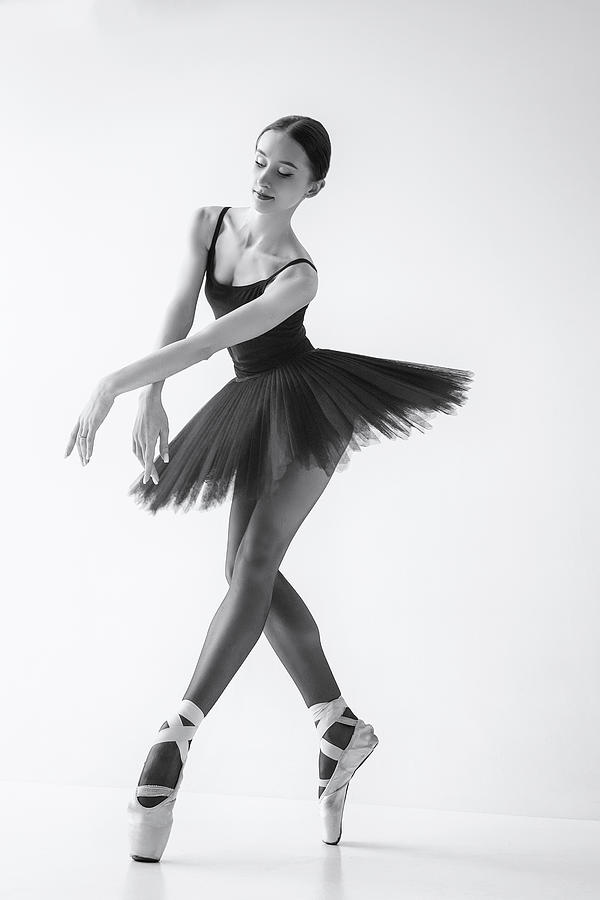 Black Swan. A Ballerina In A Black Tutu Shows Elements Of Ballet Dance In Motion Photograph by Alexandr
