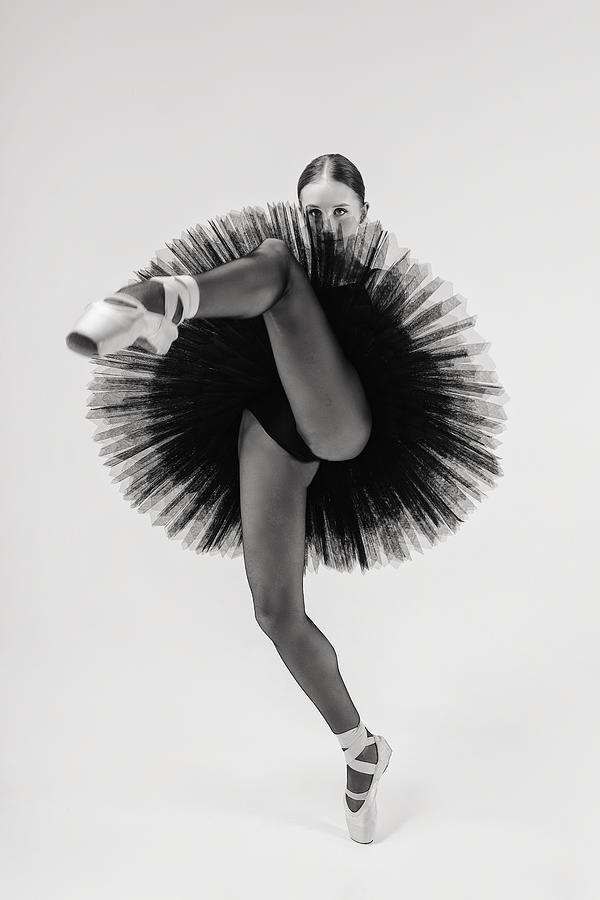 Black Swan. Ballerina In A Black Tutu Shows Elements Of Ballet Dance In Motion Photograph by Alexandr