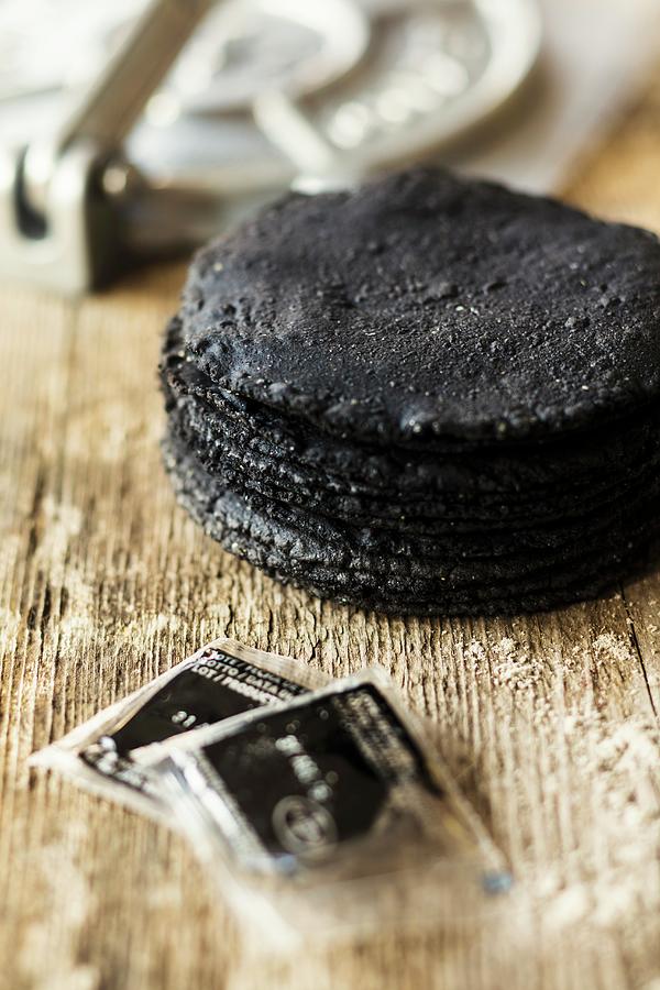 Black Tortillas On A Wooden Surface mexico Photograph by Jan Wischnewski