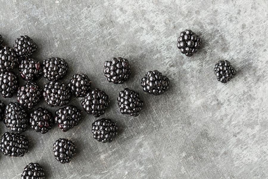 Blackberries On A Grey Metal Surface Photograph by Sarah Coghill
