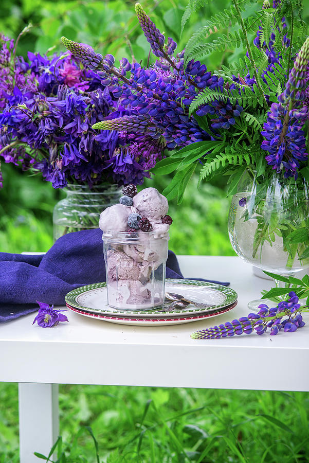 Blackberry Ice Cream In A Glass Between Blue Flowers Photograph by Irina Meliukh