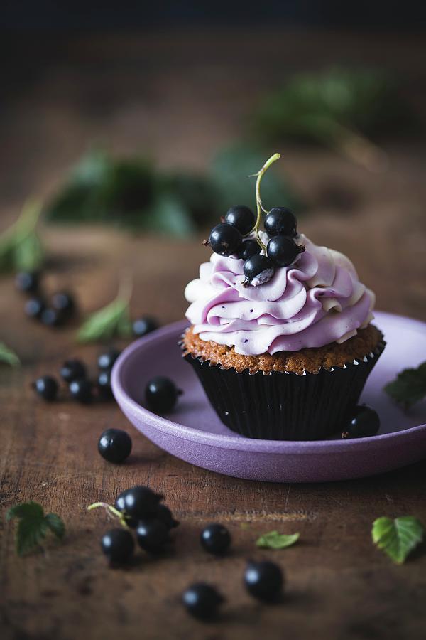 Blackcurrant And White Chocolate Cupcake On A Plate Photograph by Malgorzata Laniak