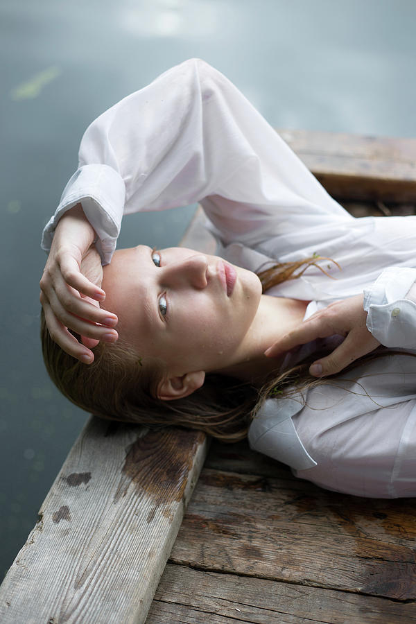 Blonde Teenage Girl In White Shirt Lies By The Lake Photograph by Cavan ...