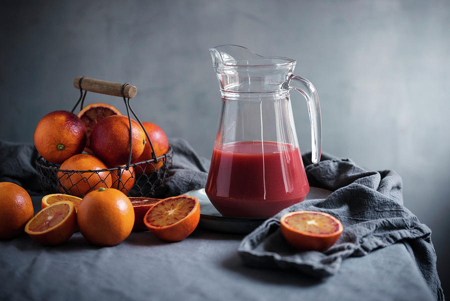 Blood Orange Juice In A Glass Jug With Fresh Fruit Photograph by Kati Neudert