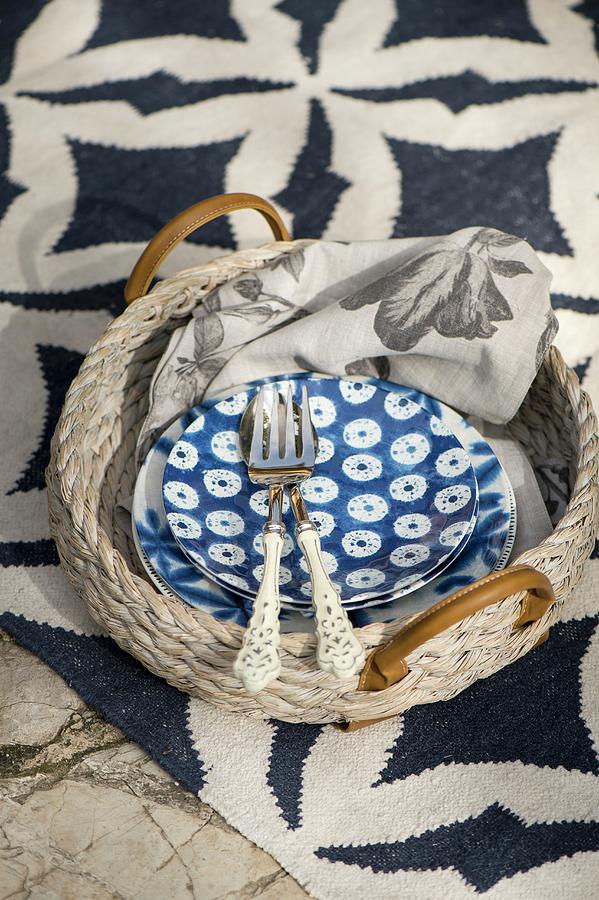 Blue And White Crockery On Wicker Tray On Patterned Rug Photograph by Winfried Heinze