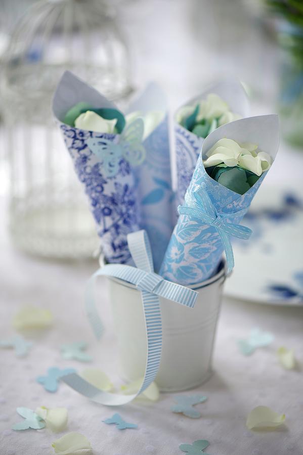 Blue And White Patterned Paper Cones Of Petals For Wedding Confetti Photograph by Winfried Heinze
