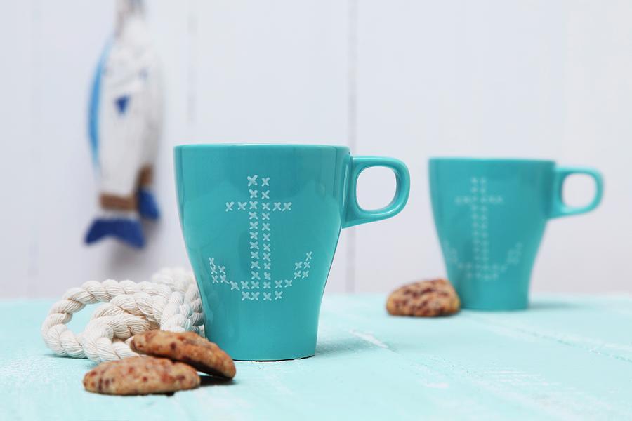 Blue Mugs With Anchor Motifs In Cross-stitch Look Photograph by Thordis Rggeberg