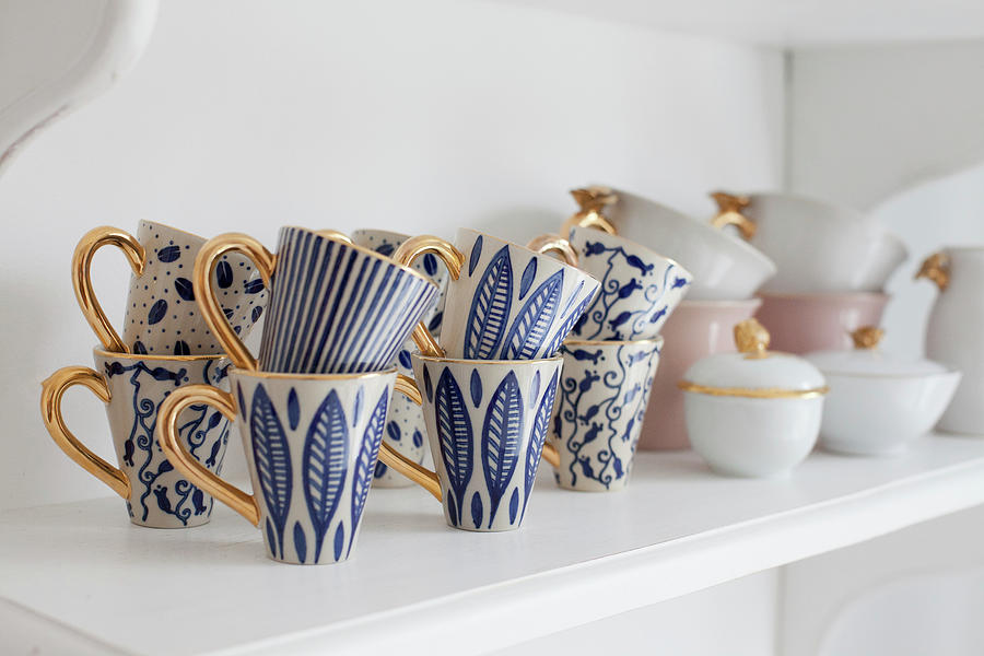 Blue-patterned Mugs With Gilt Handles On Shelf Photograph by Camilla Isaksson