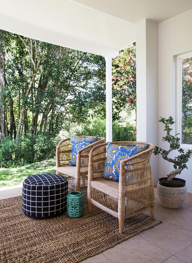 Blue Patterned Scatter Cushions On Two Wicker Armchairs On Roofed Terrace Photograph by Great Stock!