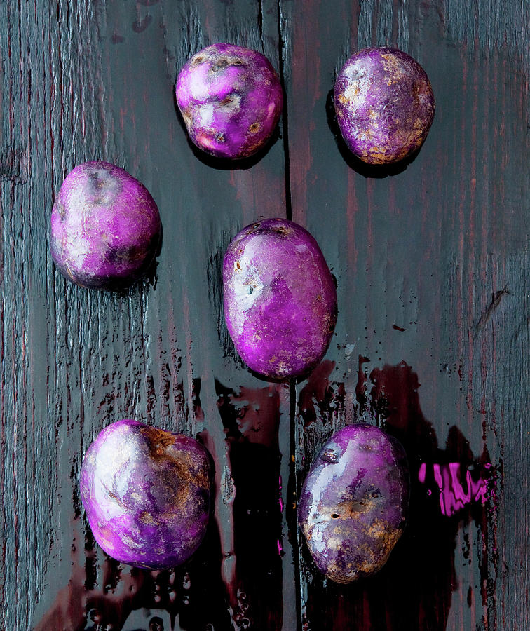Blue Potatoes On A Dark, Wet Wooden Surface seen From Above Photograph by Udo Einenkel