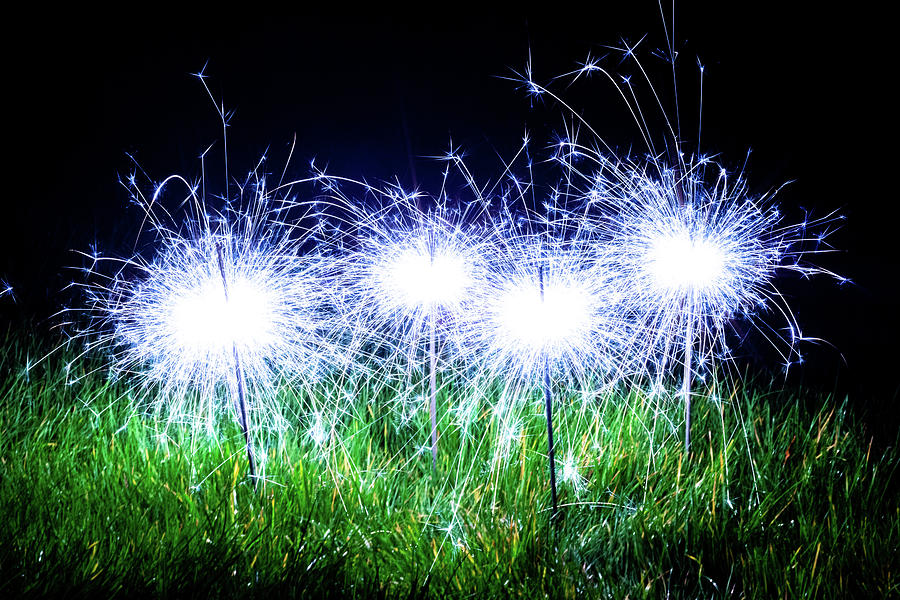 Blue sparklers in the grass Photograph by Scott Lyons