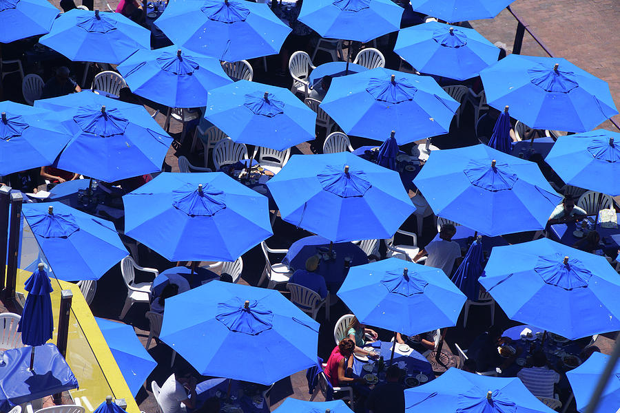 Blue umbrellas of outdoor restaurant Photograph by Steve Estvanik