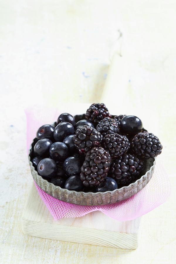 Blueberries And Blackberries In A Tartlet Dish Photograph by Miriam Rapado