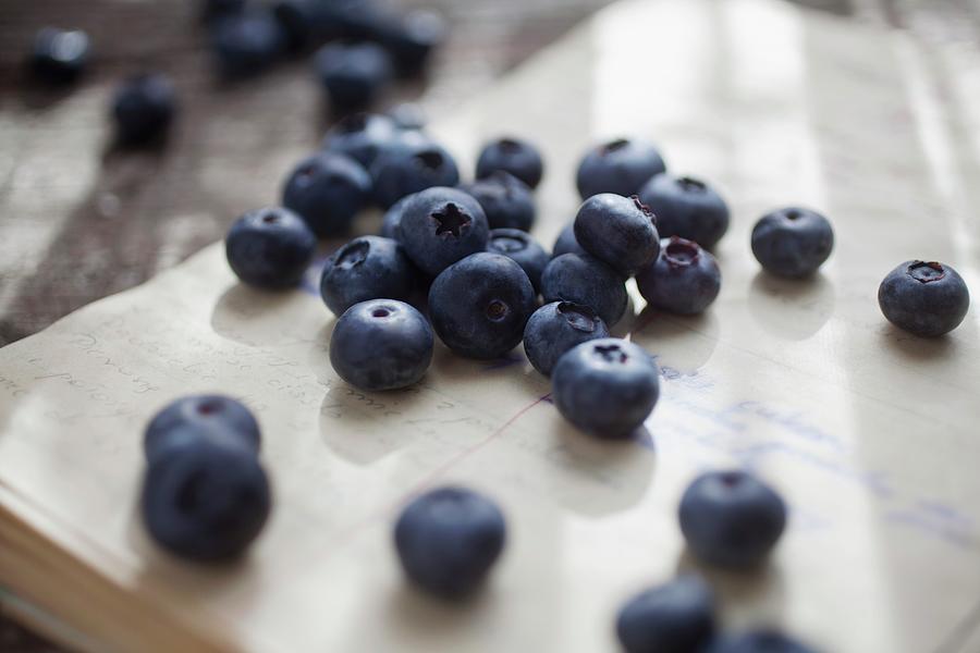 Blueberries On A Sheet Of Paper Covered In Writing Photograph by Stepien, Malgorzata