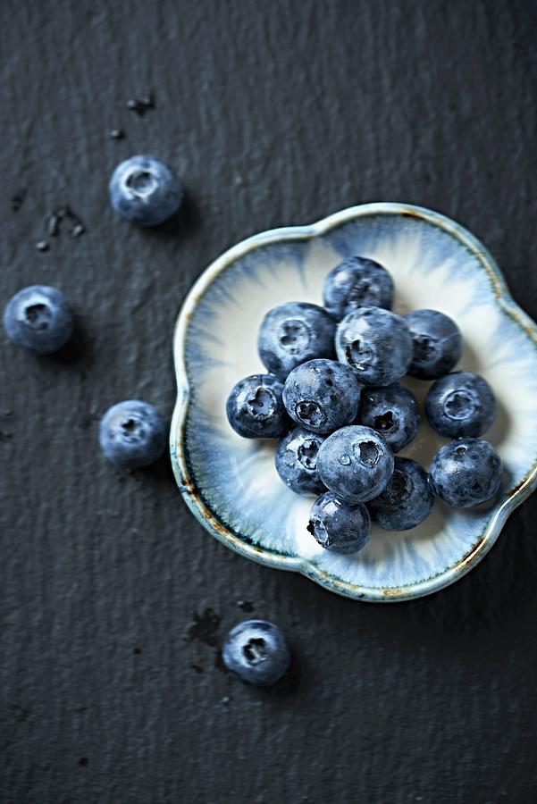 Blueberries On A Small Ceramic Plate Photograph by B.&.e.dudzinski