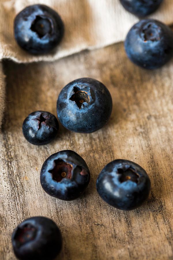 Blueberries On A Wooden Surface close-up Photograph by Sandra Krimshandl-tauscher