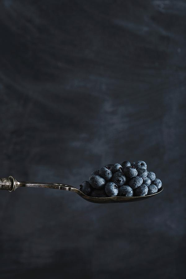 Blueberries On Spoon On A Dark Surface Photograph by Rose Hewartson