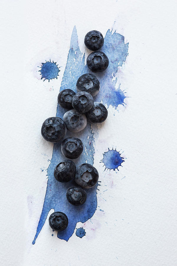 Blueberries Over Blue Water Colour Painted Surface Photograph by Stacy Grant