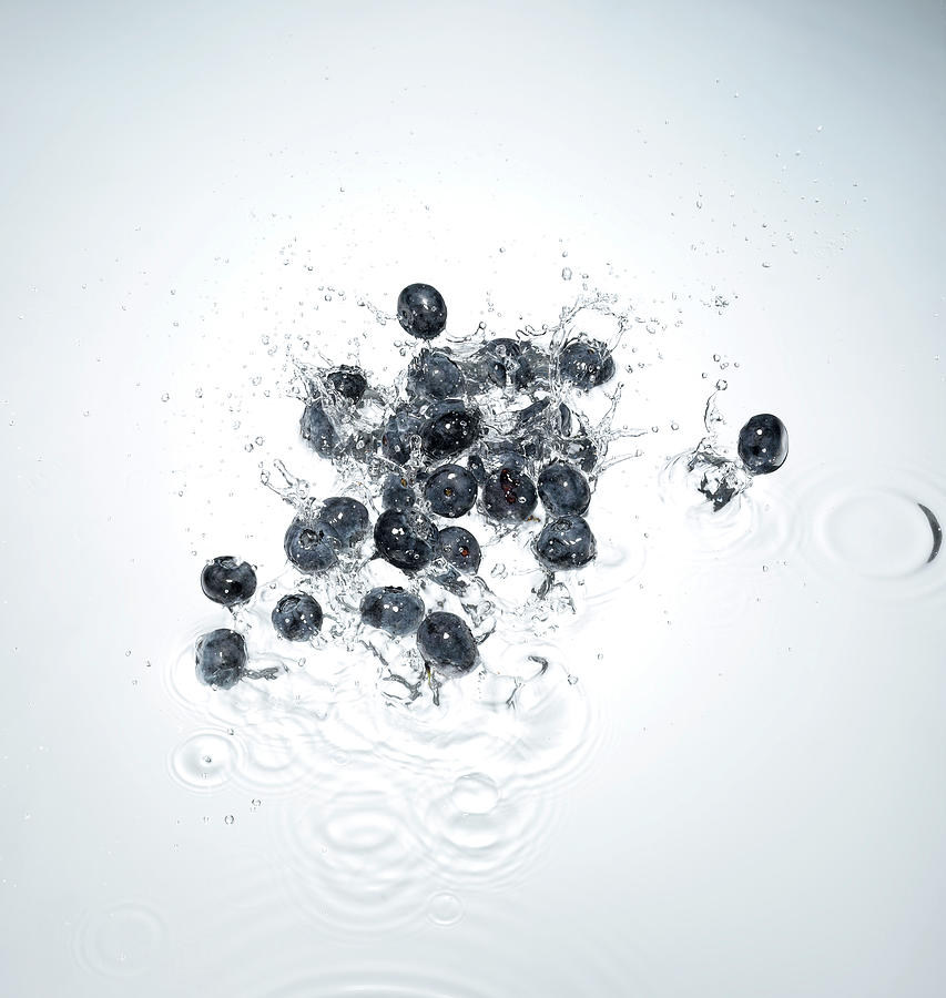 Blueberries Splashing In To Water Photograph by Chris Stein