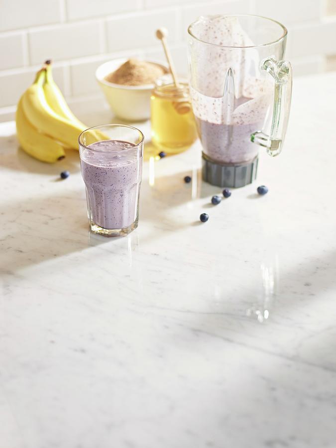 Blueberry And Banana Smoothie In A Blender Jug And In A Glass With Sugar And Family Photograph by Clinton Hussey