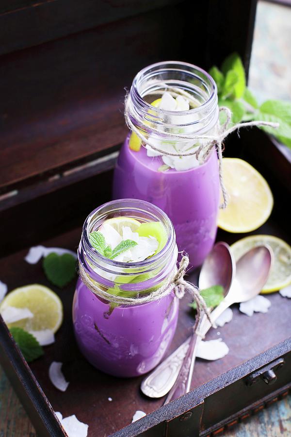 Blueberry Smoothies With Grated Coconut, Lemon, Mint And Silver Spoons Photograph by Natalia Mantur