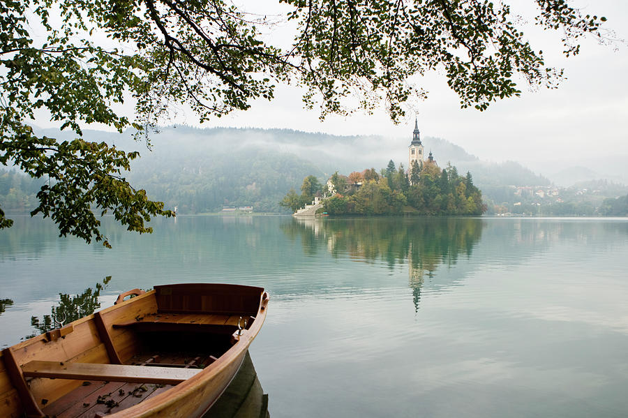 Boat And Castle In Bled, Slovenia Photograph by Michele Westmorland