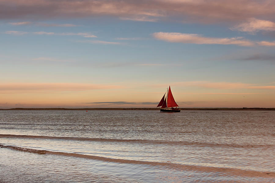 Boat Off The Shore Of Brancaster Beach Photograph by Verity E. Milligan