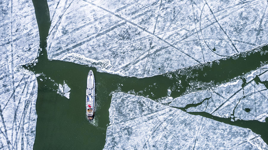 Boat On Icy Lake Photograph by Eser Karadag