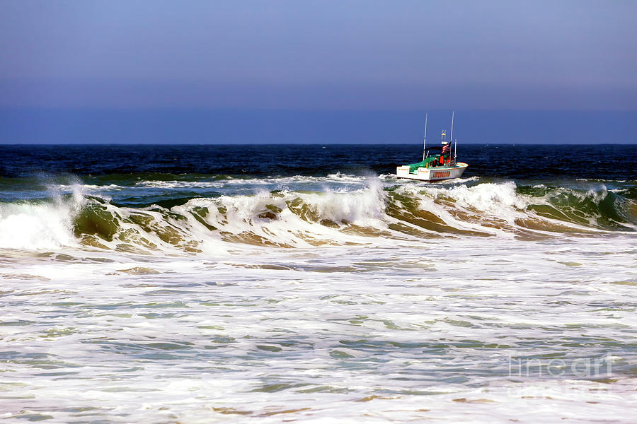 Boat Past the Waves at Zuma Beach Photograph by John Rizzuto
