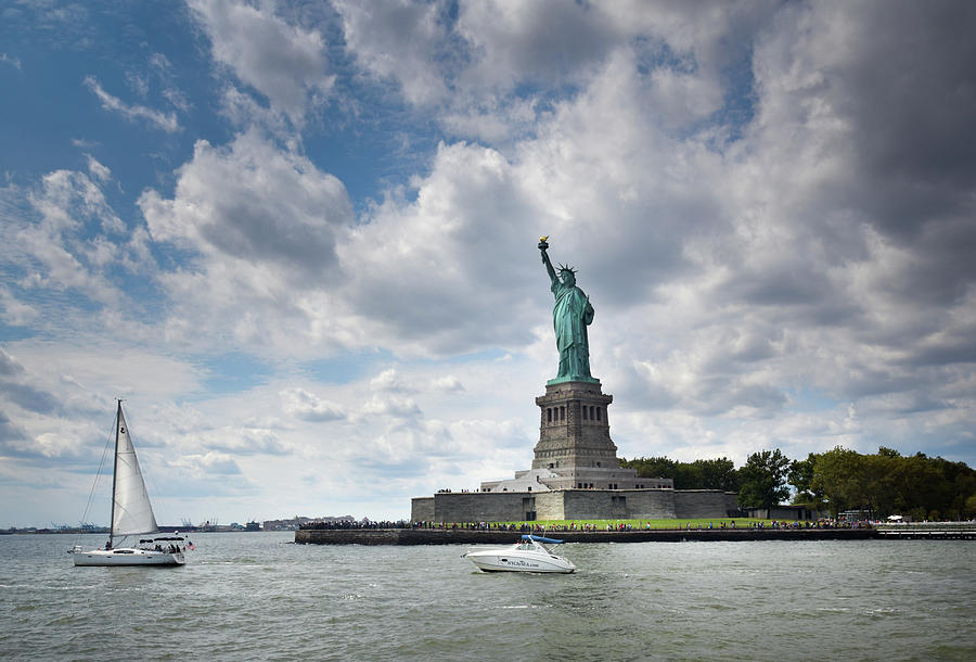 Boats And Liberty Photograph by Greg and Chrystal Mimbs